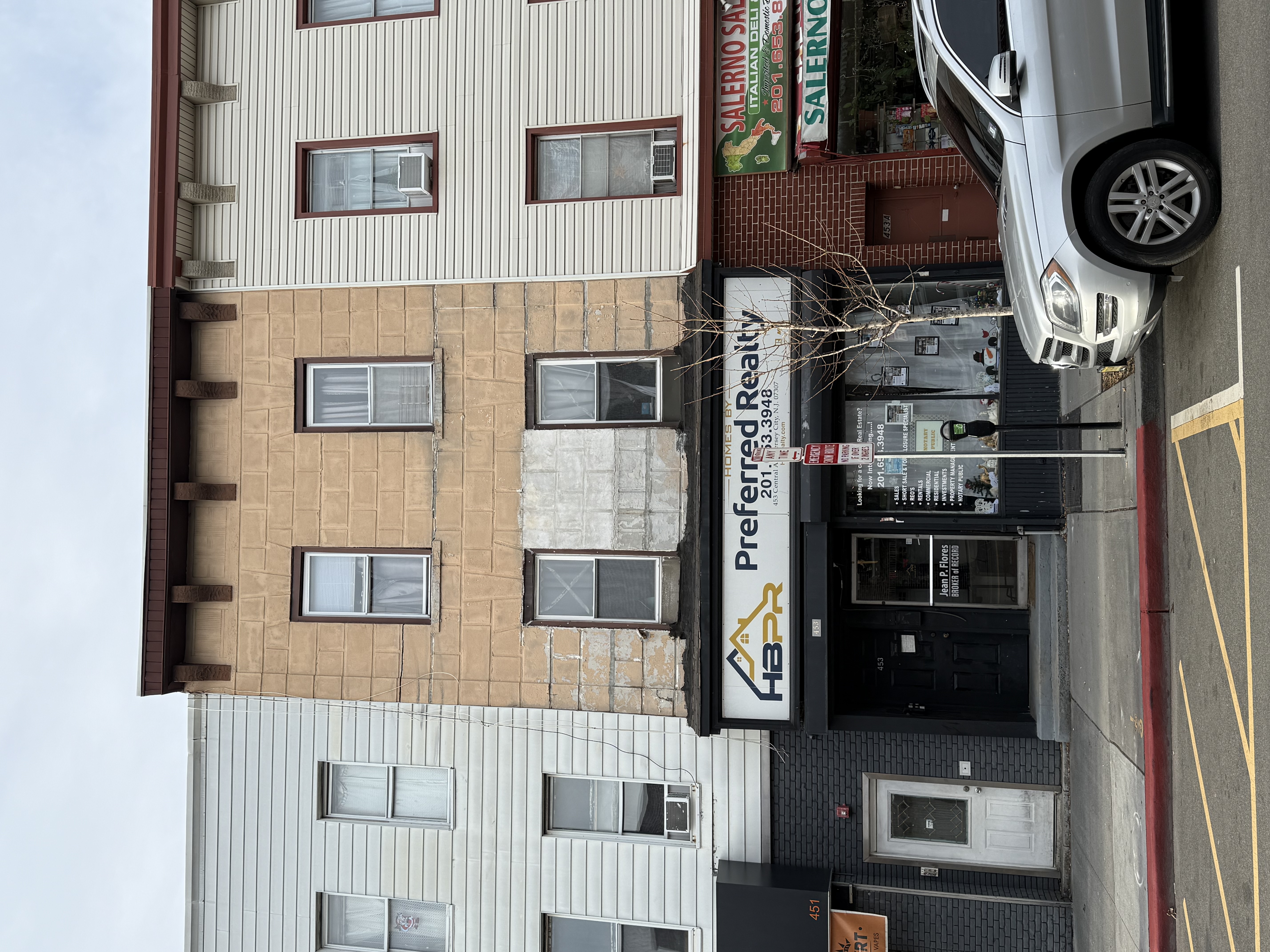 a front view of a building with parking space